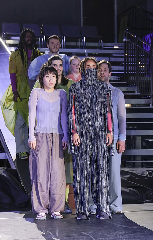 Personen stehen auf einer Bühne und sehen erstarrt aus 