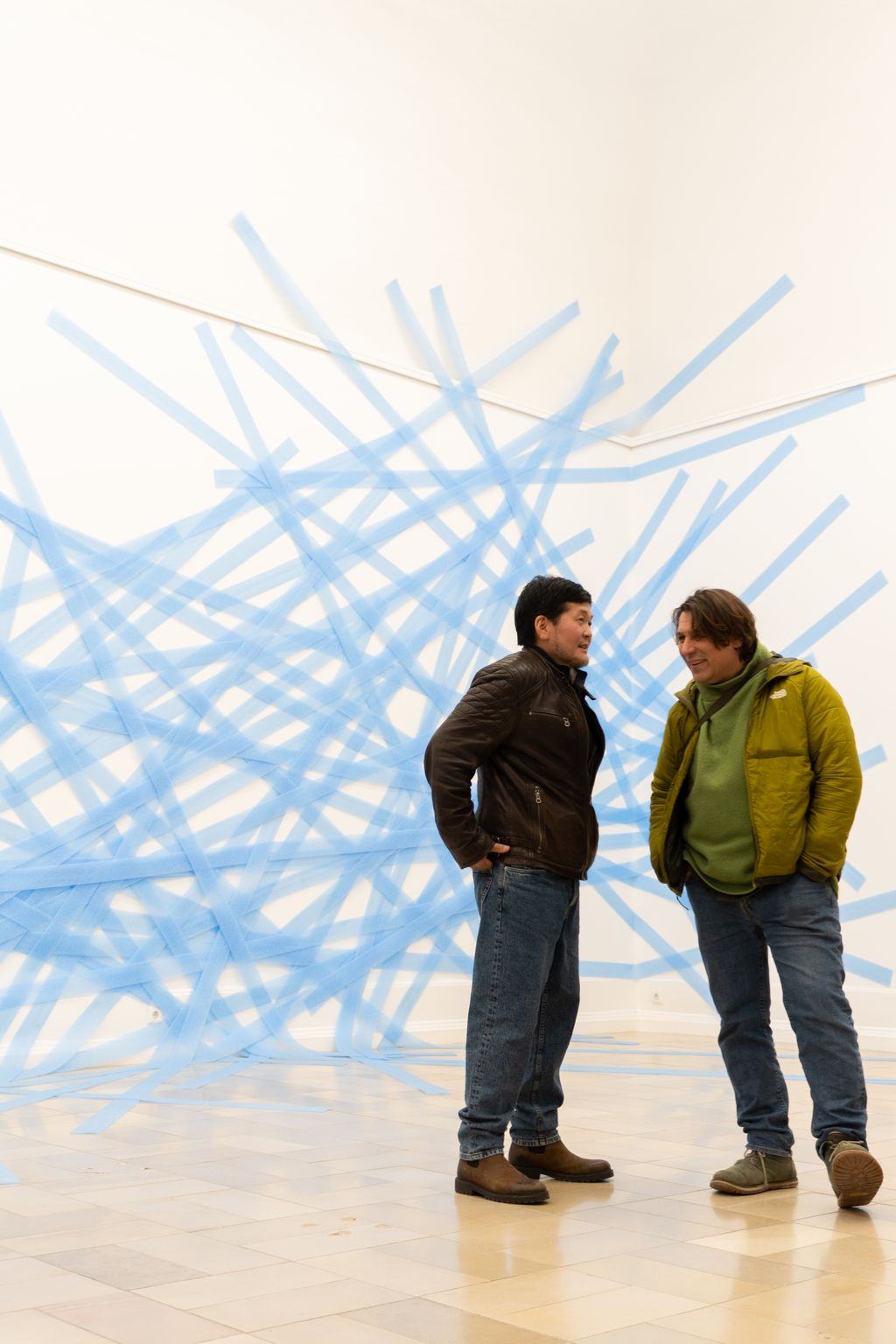 Hellblaue Dämmstoffstreifen auf die Wand und zum Teil auf den Fußboden geklebt