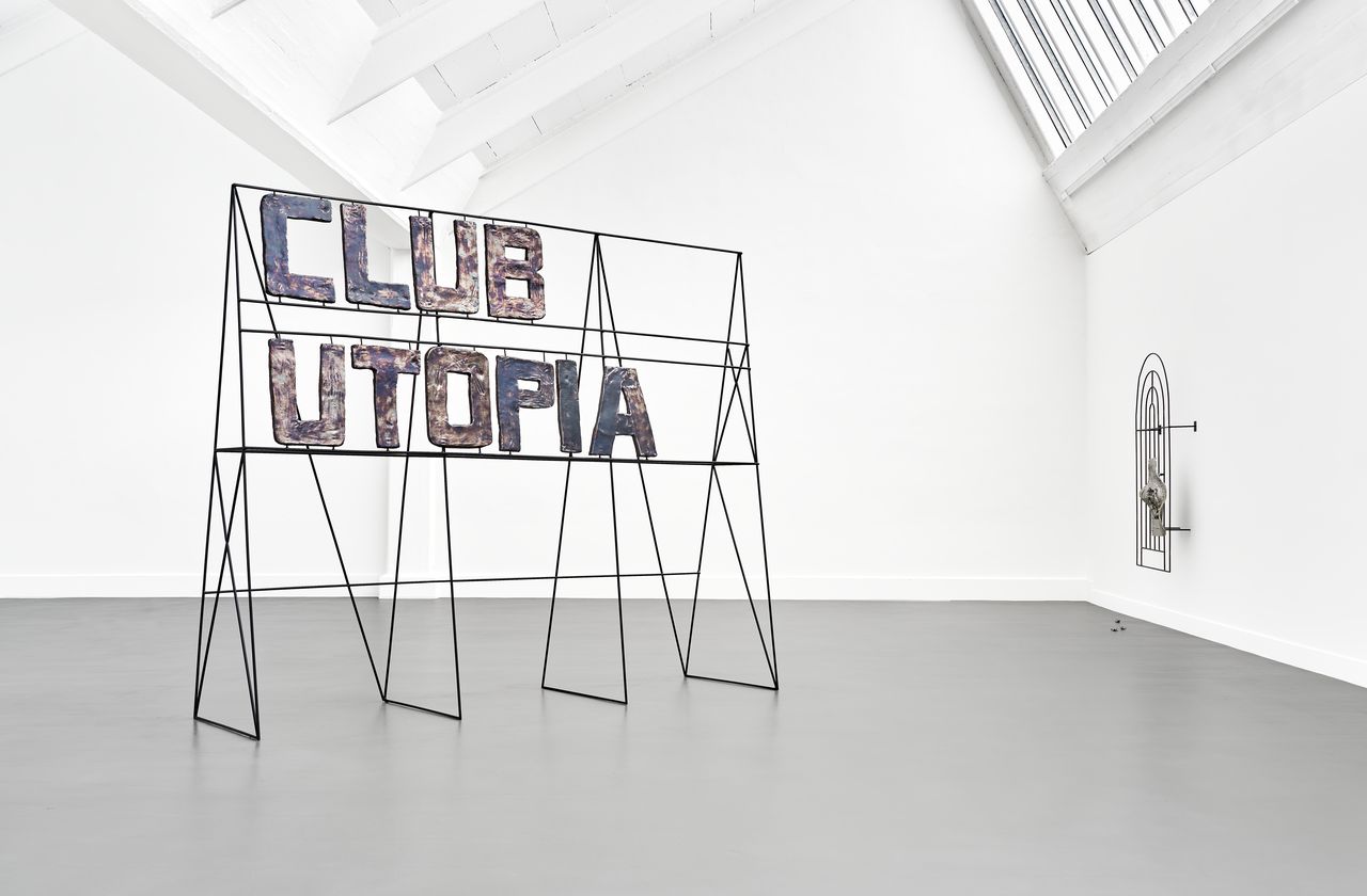 Ein Stahlgestell kündigt in großen Keramikbuchstaben wie eine Werbetafel den "Club Utopia" an.