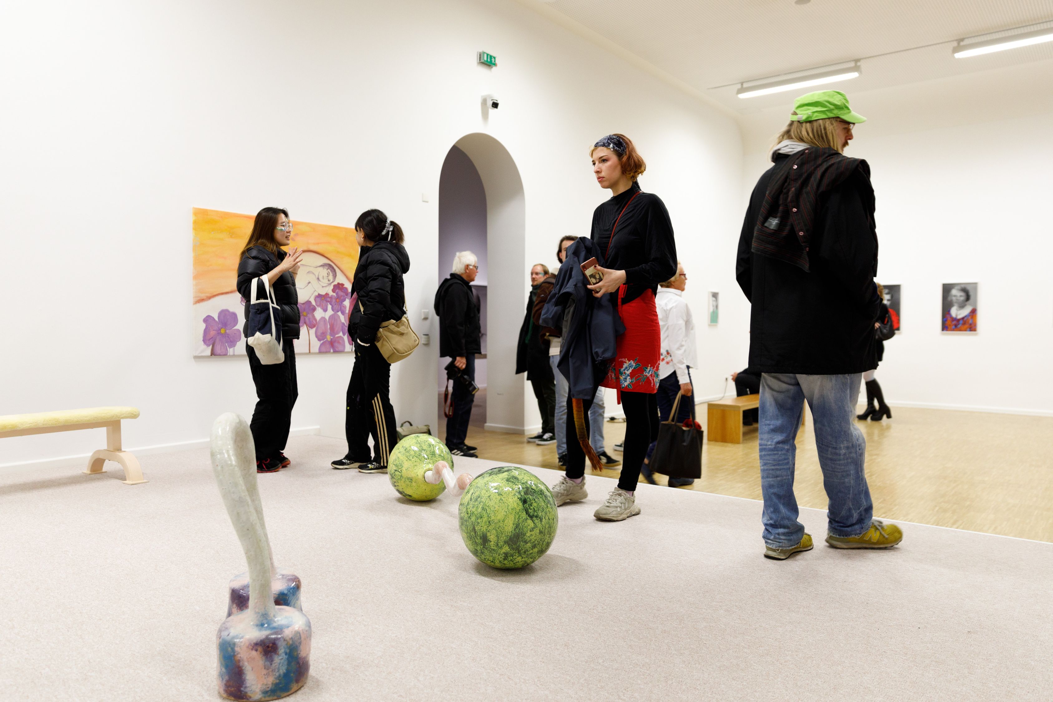 Die Installation aus Fotografien, Gemälden, einer Spiegelwand und keramischen Objekten, die an Geräte zum Bodybuilding denken lassen, deutet ein Fitness-Studio an